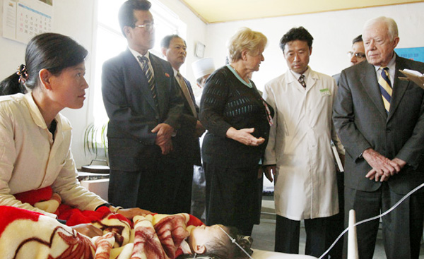 Gro Harlem Brundtland and Jimmy Carter discussing health care with doctors at Pyongsong City Hospital, North Korea, April 2011